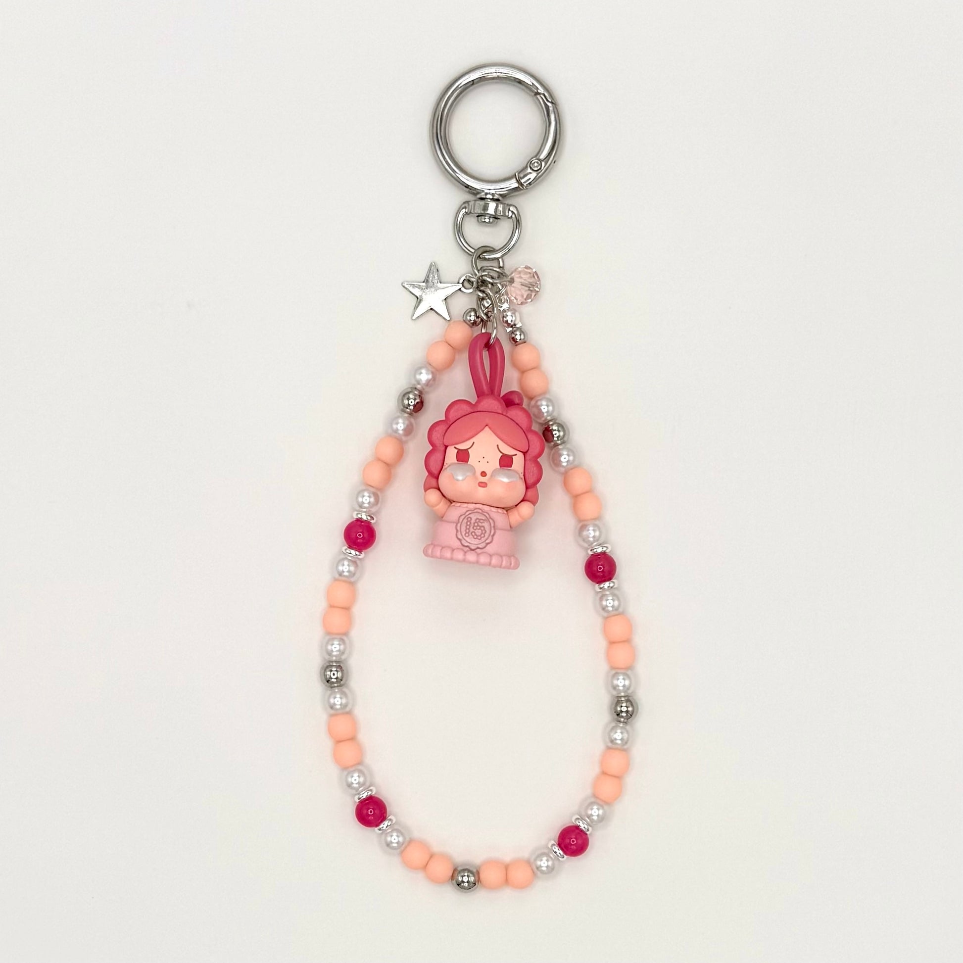 Keychain with cartoon character and beaded chain on a white background