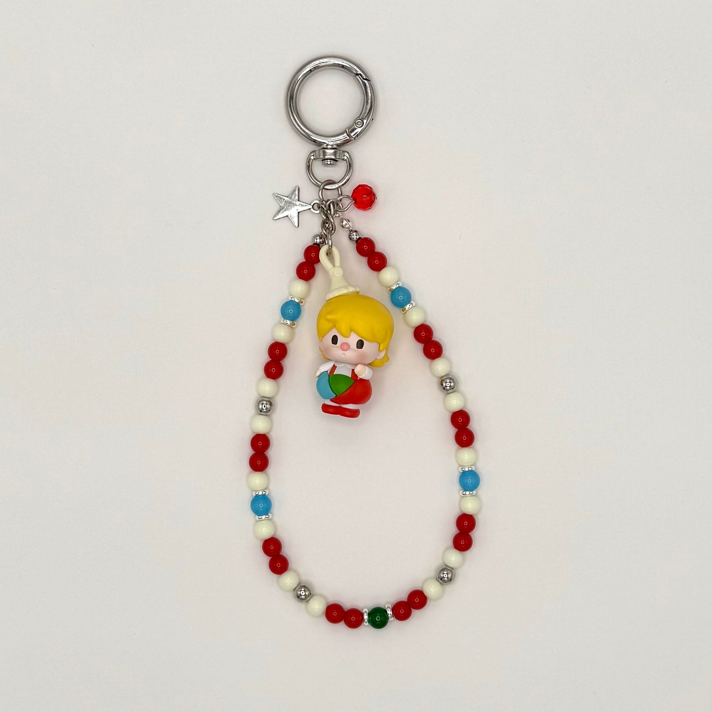 Keychain with beads and a small figurine on a white background