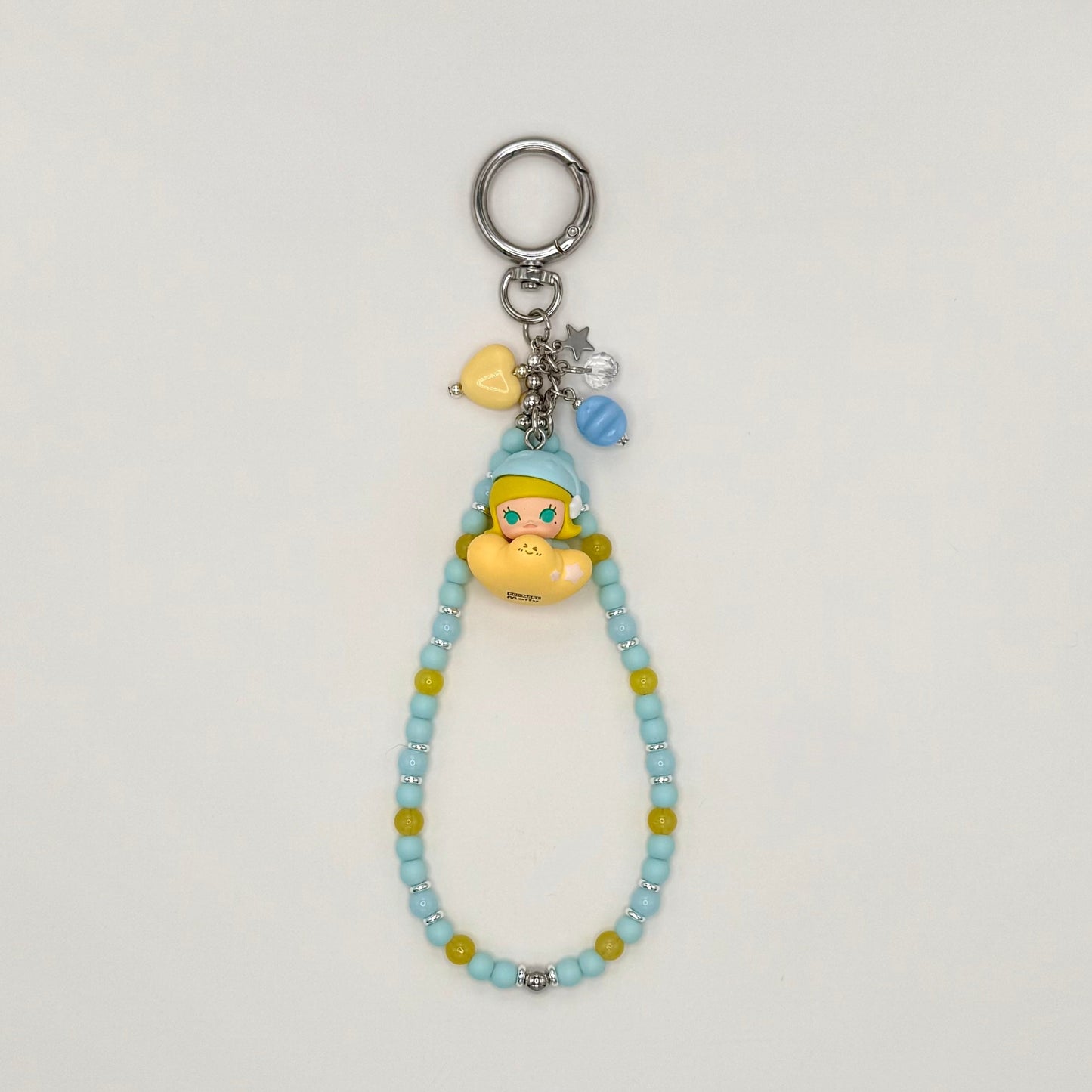 Beaded keychain with character charm on a light gray background