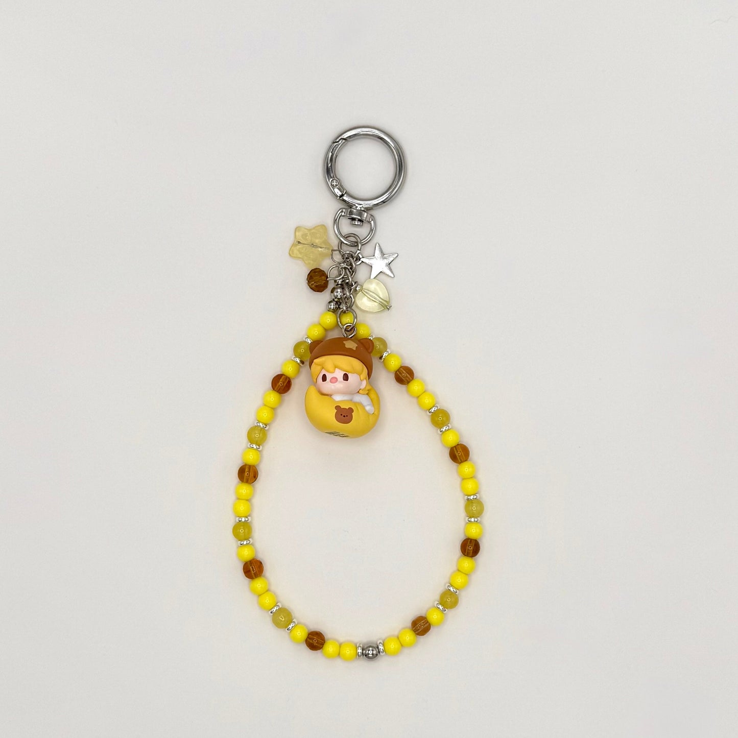 Beaded keychain with a small figure on a light gray background